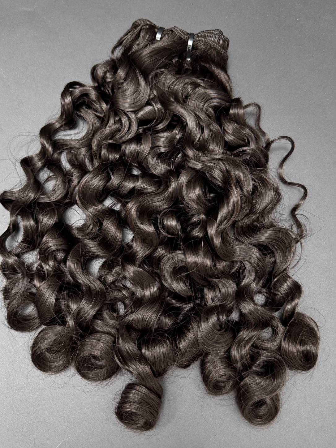 Caribbean Curly frontal wig on a mannequin head, showing defined spiral curls